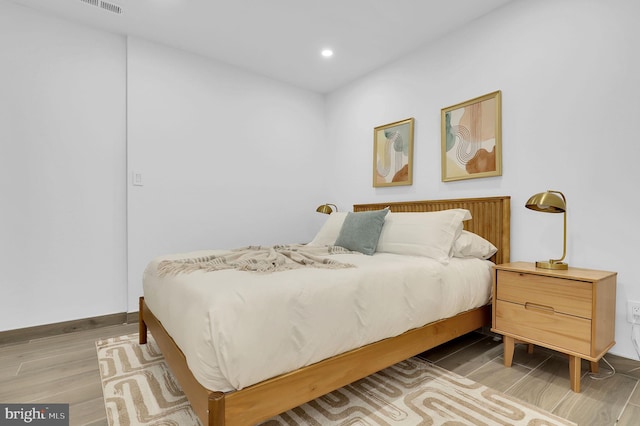 bedroom featuring recessed lighting, baseboards, and light wood-type flooring