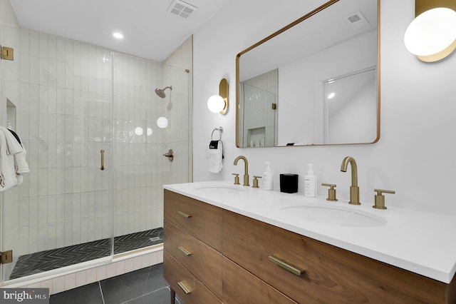 full bath featuring double vanity, visible vents, a sink, and a stall shower