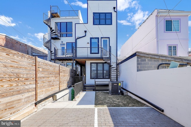 back of house with stairs, fence, and cooling unit