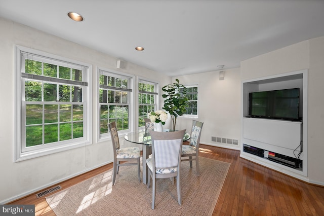 dining room with wood-type flooring, baseboards, and visible vents