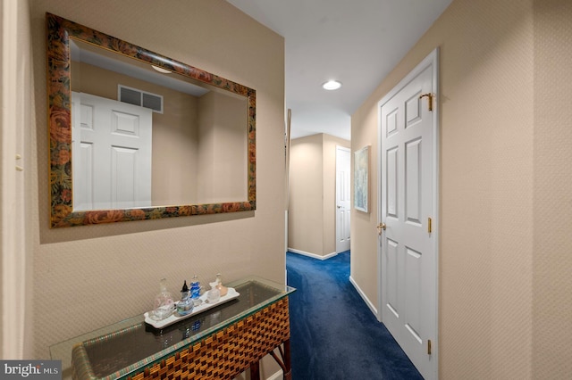 hall with recessed lighting, baseboards, visible vents, and dark colored carpet