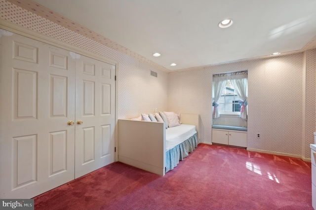 carpeted bedroom with recessed lighting, wallpapered walls, visible vents, and a closet