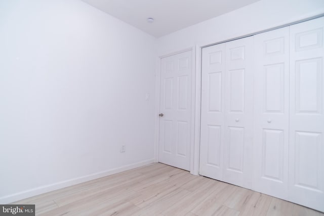 2 Edgewood Ln, Levittown, PA 19054 - unfurnished bedroom with baseboards, a closet, and light wood-style flooring