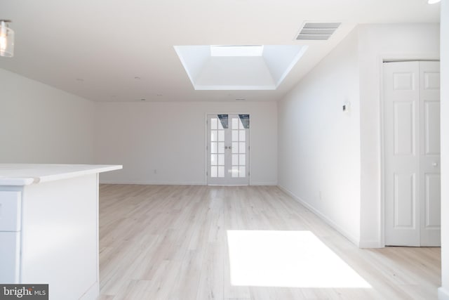 2 Edgewood Ln, Levittown, PA 19054 - unfurnished living room with french doors, light wood-style flooring, baseboards, a skylight, and visible vents