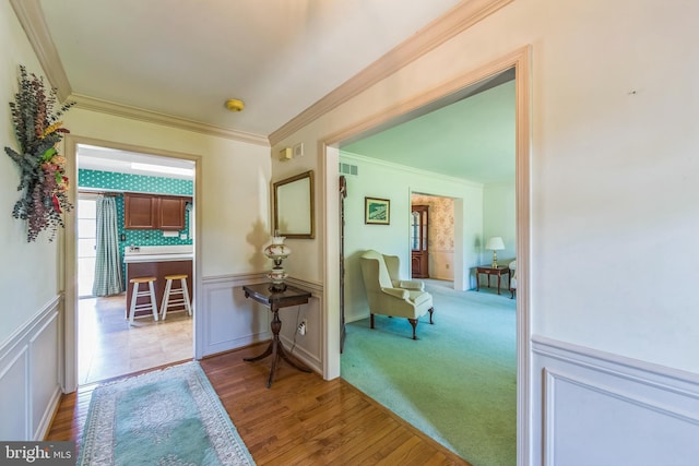 2707 E Crossing Cir, Norristown, PA 19403 - corridor featuring ornamental molding, wood finished floors, a wainscoted wall, and a decorative wall
