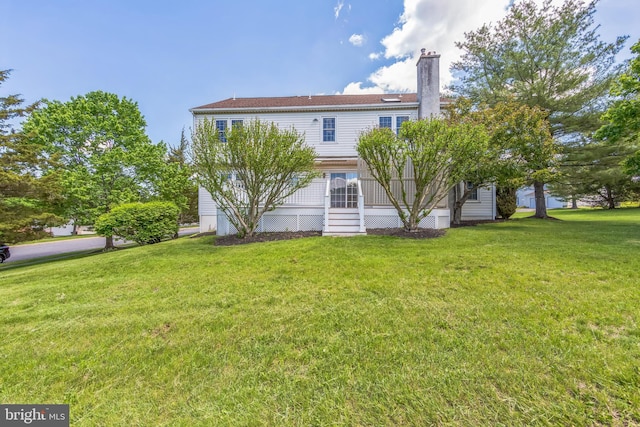2707 E Crossing Cir, Norristown, PA 19403 - rear view of house with a yard and a chimney