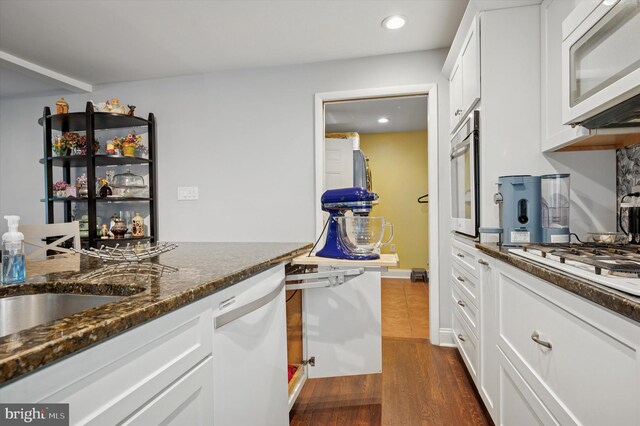 628 Edge Hill Rd, Glenside, PA 19038 - kitchen with white appliances, dark stone counters, white cabinets, dark wood-type flooring, and recessed lighting