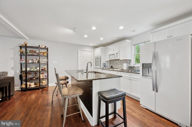 628 Edge Hill Rd, Glenside, PA 19038 - kitchen featuring white appliances, a sink, dark wood-type flooring, a kitchen bar, and recessed lighting