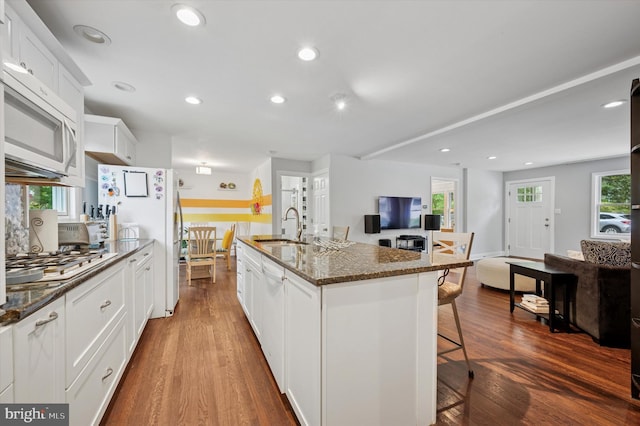628 Edge Hill Rd, Glenside, PA 19038 - kitchen featuring a sink, a kitchen breakfast bar, freestanding refrigerator, gas cooktop, and dark wood-style floors