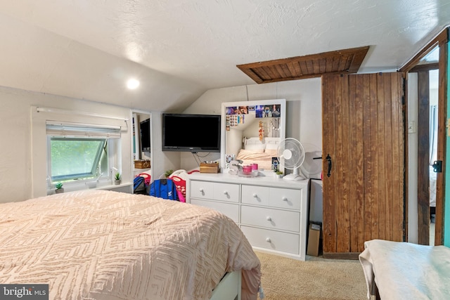 bedroom featuring light colored carpet and vaulted ceiling