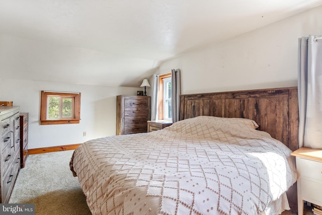 bedroom featuring baseboards, vaulted ceiling, and carpet