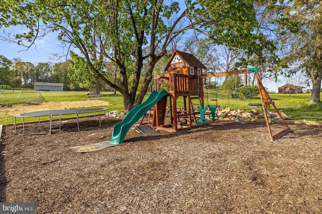 community playground featuring a trampoline and a yard