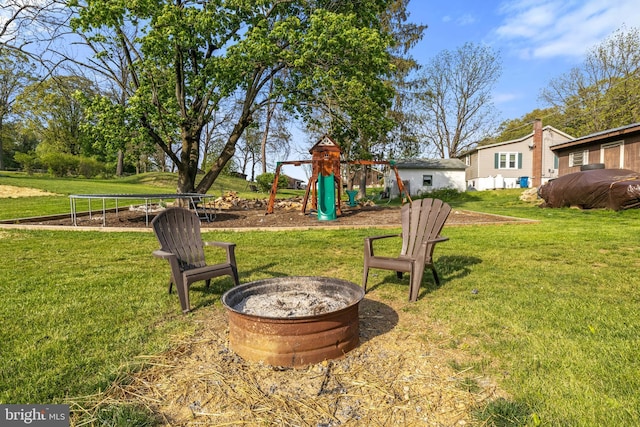 view of yard featuring a playground and a fire pit