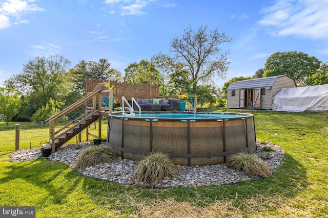 view of pool with a fenced in pool, an outbuilding, a yard, and an outdoor hangout area