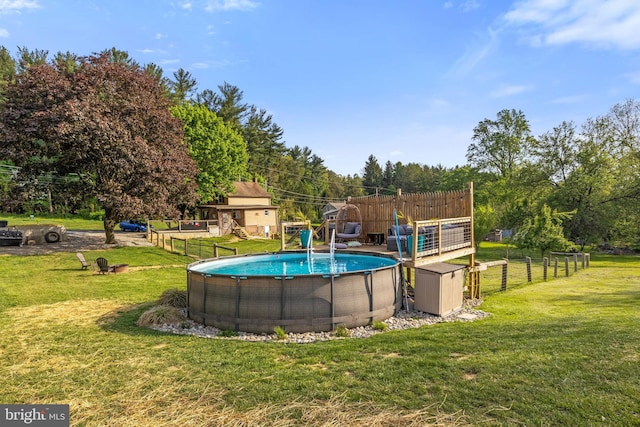 outdoor pool featuring a lawn, fence, an outdoor structure, and a storage shed