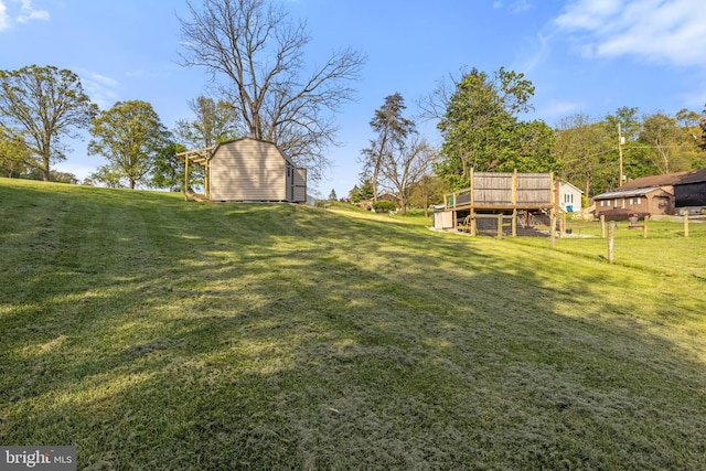 view of yard with an outdoor structure and a deck
