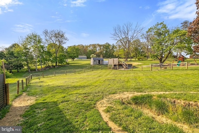 view of yard featuring a playground and fence