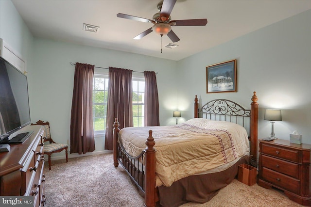 bedroom with carpet floors, ceiling fan, baseboards, and visible vents