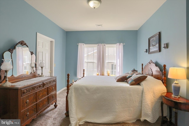 carpeted bedroom with baseboards and visible vents
