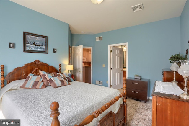 bedroom featuring a spacious closet, light carpet, and visible vents