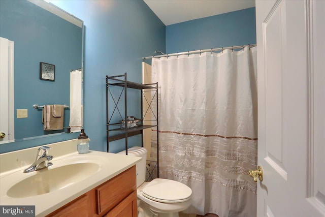 full bathroom with vanity, curtained shower, and toilet