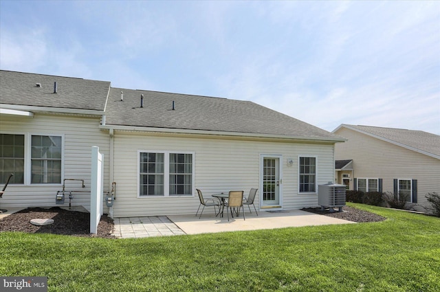 back of house featuring a lawn, central AC unit, a patio area, and a shingled roof