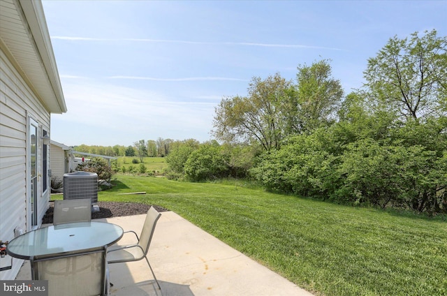 view of yard featuring central AC unit and a patio area