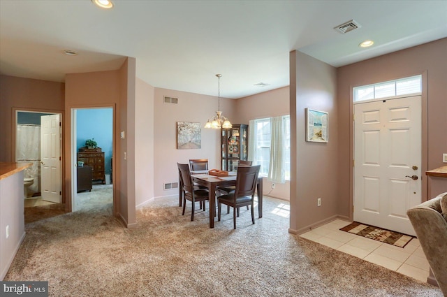 dining room with visible vents, a wealth of natural light, and light carpet