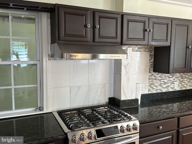kitchen with stainless steel range with gas stovetop, dark brown cabinetry, backsplash, and extractor fan