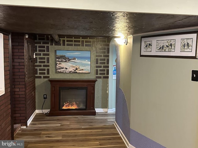 interior space featuring baseboards and wood finished floors