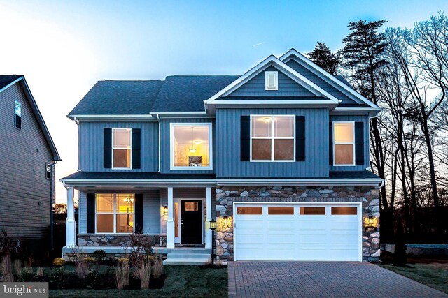 1094 Linden Tree Dr, Taft Model, Annapolis, MD 21409 - craftsman-style home featuring covered porch, stone siding, a garage, decorative driveway, and roof with shingles
