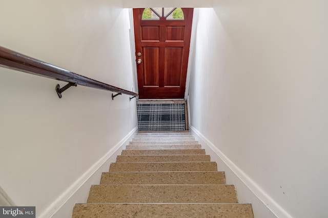 stairs featuring baseboards