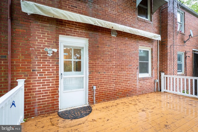 view of exterior entry with brick siding