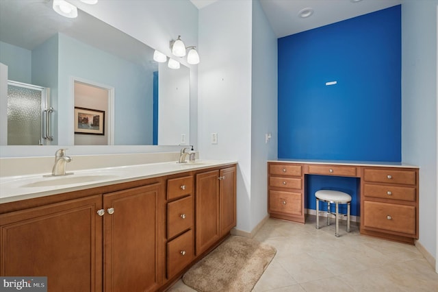 bathroom with tile patterned floors, double vanity, a stall shower, and a sink