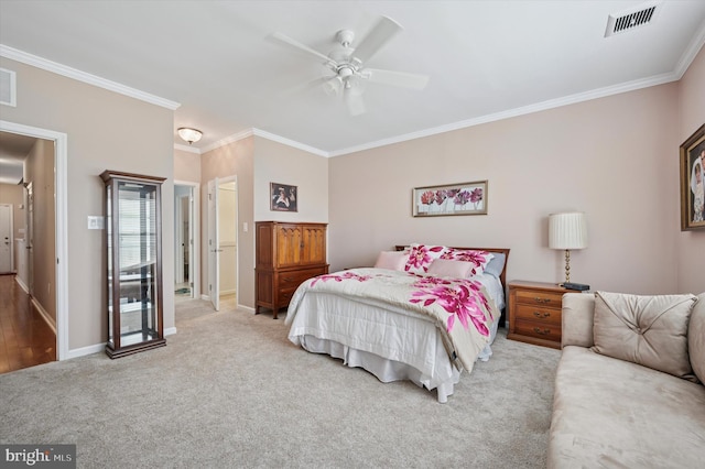 bedroom with visible vents, ornamental molding, and carpet floors