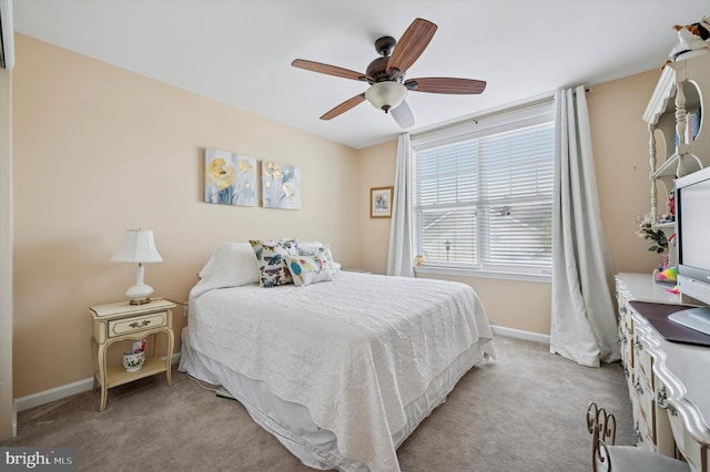 bedroom with baseboards, a ceiling fan, and light colored carpet