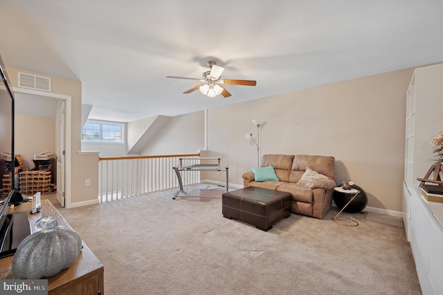 living area with carpet, visible vents, a ceiling fan, and baseboards