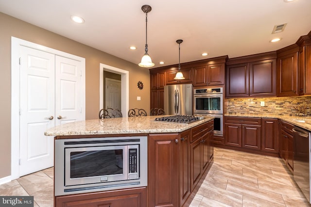 kitchen with recessed lighting, appliances with stainless steel finishes, light stone counters, and visible vents