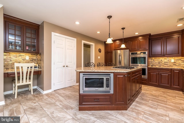 kitchen with recessed lighting, appliances with stainless steel finishes, decorative backsplash, and a center island with sink