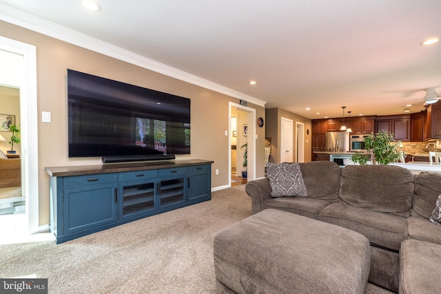living area featuring baseboards, ornamental molding, light carpet, and recessed lighting