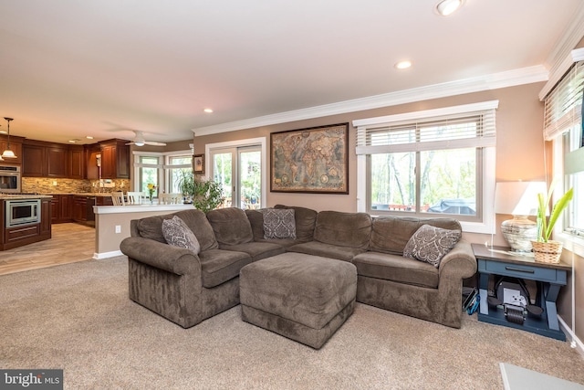 living area with crown molding, ceiling fan, recessed lighting, and light colored carpet