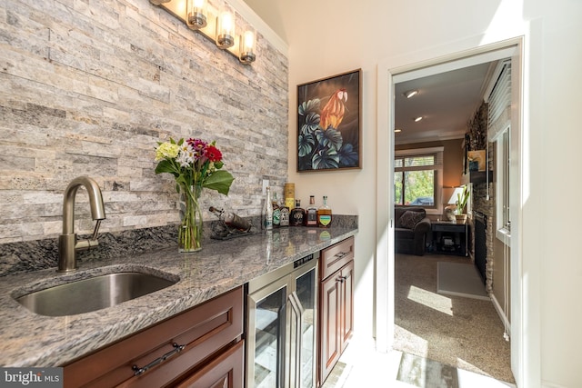 bar with wet bar, tasteful backsplash, a sink, wine cooler, and ornamental molding