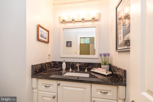 bathroom with crown molding and vanity