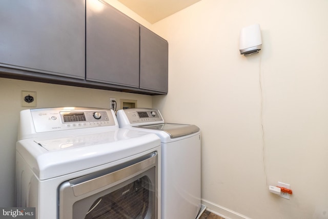 laundry room featuring cabinet space and washer and dryer