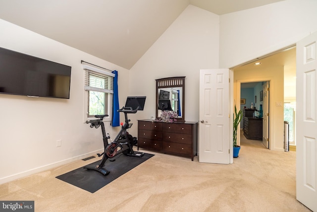 exercise room with carpet flooring, high vaulted ceiling, visible vents, and baseboards