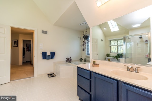 bathroom featuring tile patterned flooring, a shower stall, a garden tub, visible vents, and lofted ceiling with skylight