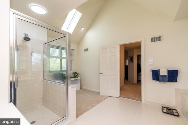 full bath featuring a skylight, visible vents, a shower stall, and high vaulted ceiling
