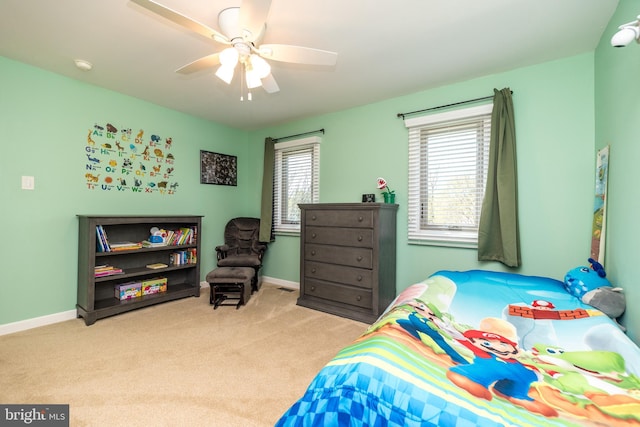 bedroom with carpet flooring, ceiling fan, multiple windows, and baseboards