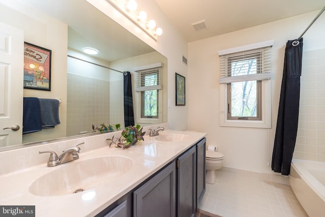 bathroom featuring toilet, visible vents, a sink, and tile patterned flooring