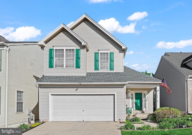 traditional-style home with an attached garage, driveway, and a shingled roof